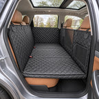 Black quilted hammock installed across the rear bench with seat-belt openings accessible