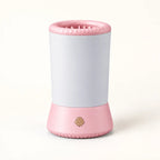 Pink electric paw washer with silicone opening and power button
